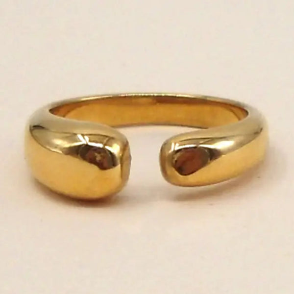 Gold ring on a light beige background