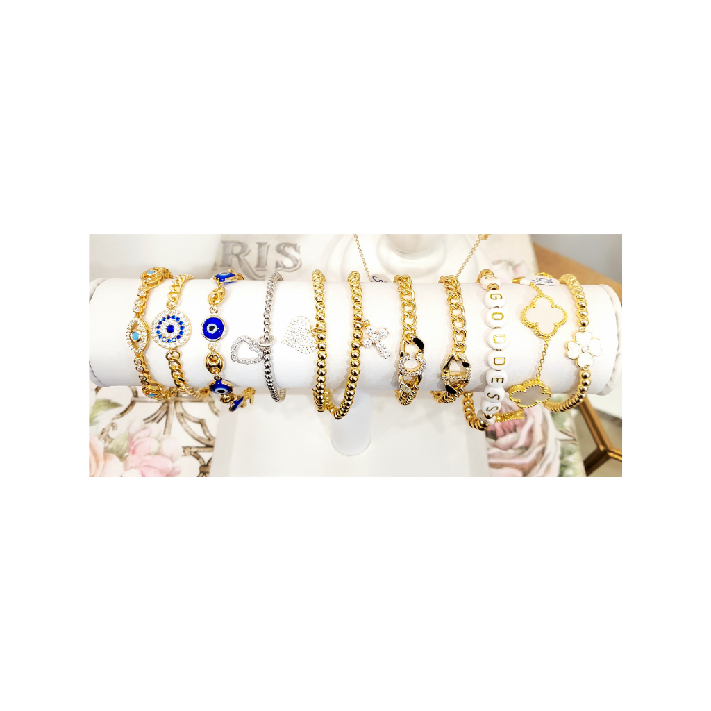 Multiple stretch charm bracelets in gold or silver.