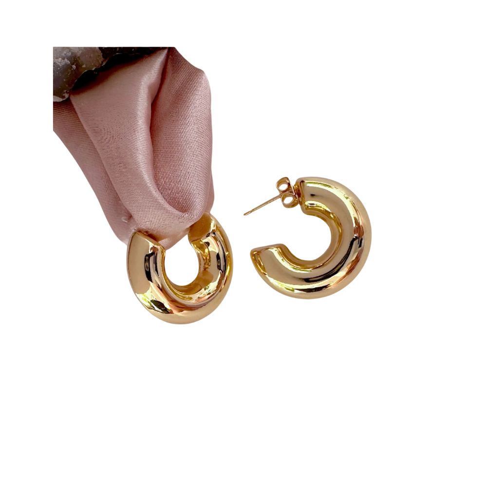 A pair of gold puffy medium sized hoops